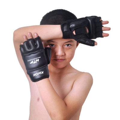 young boy wearing black martial arts gloves 