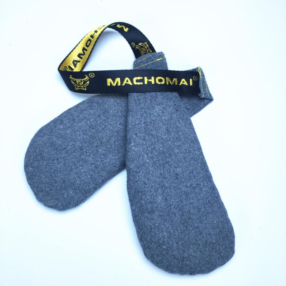 Gray dog toy with a black and yellow 'Machoman' strap on a white background