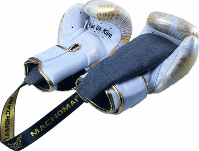 Pair of white boxing gloves with gold accents and a black belt on a white background