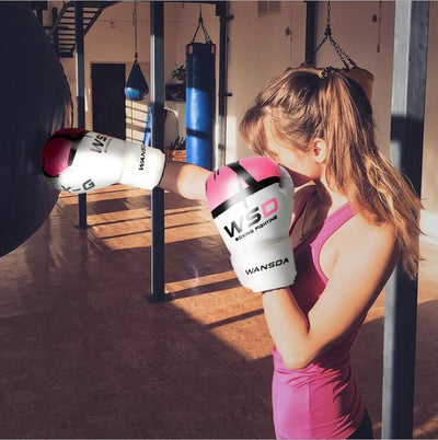 Woman wearing boxing gloves training in a gym